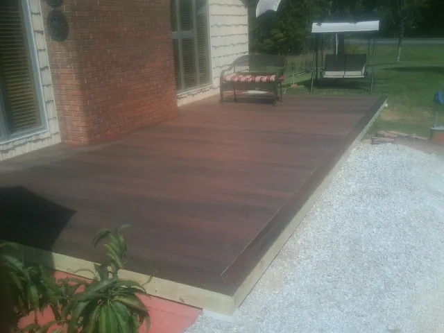 Freshly stained wood deck built against a brick home in Chisago City